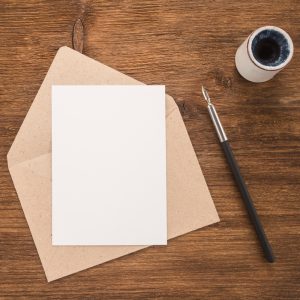 Envelope,,Ink,Pen,,Inkwell,On,Wood,Table