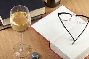 Reading,Glasses,And,A,Glass,Of,Wine,With,Some,Books